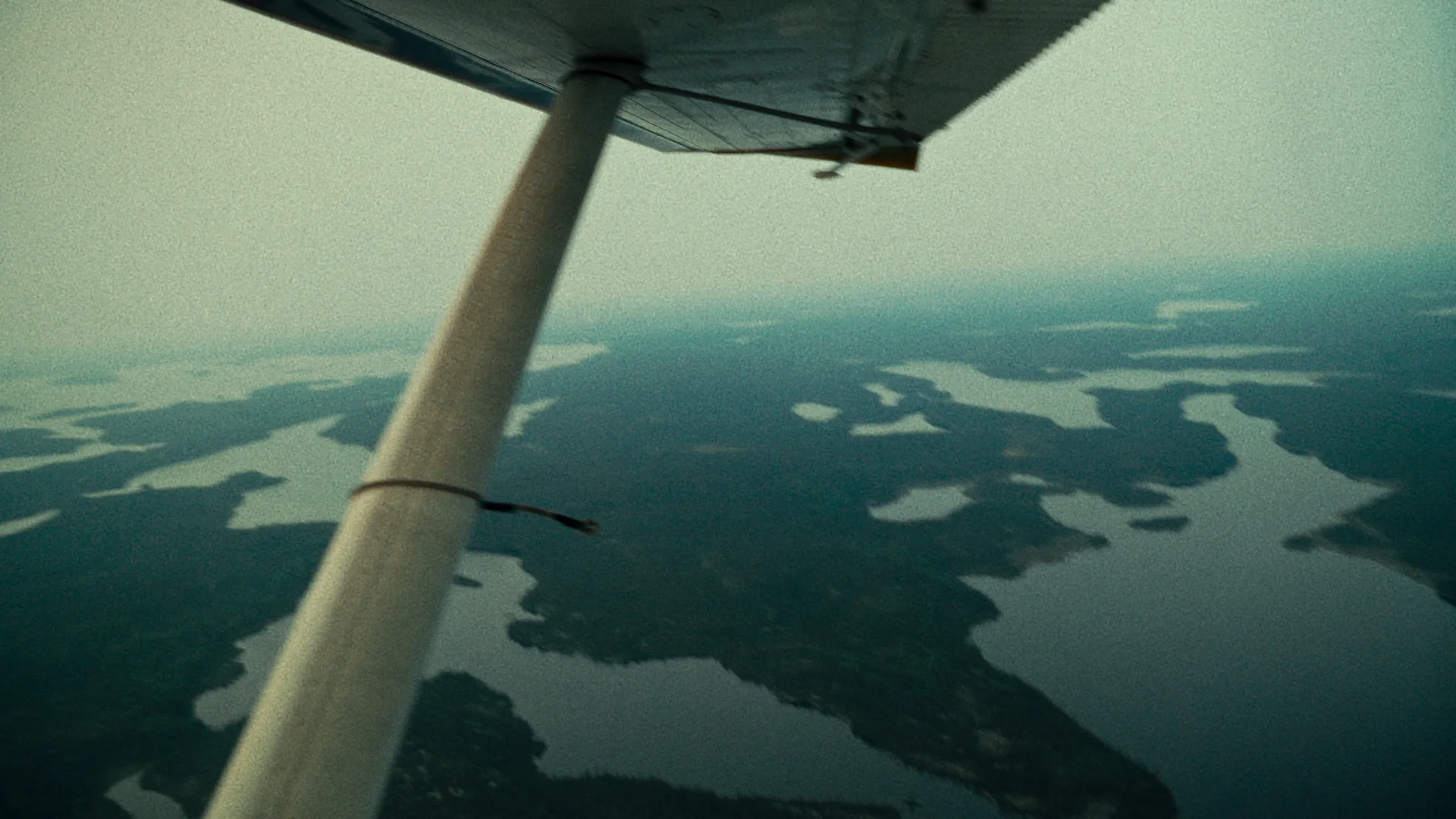 Lakes and islands below the wing strut of a floatplane