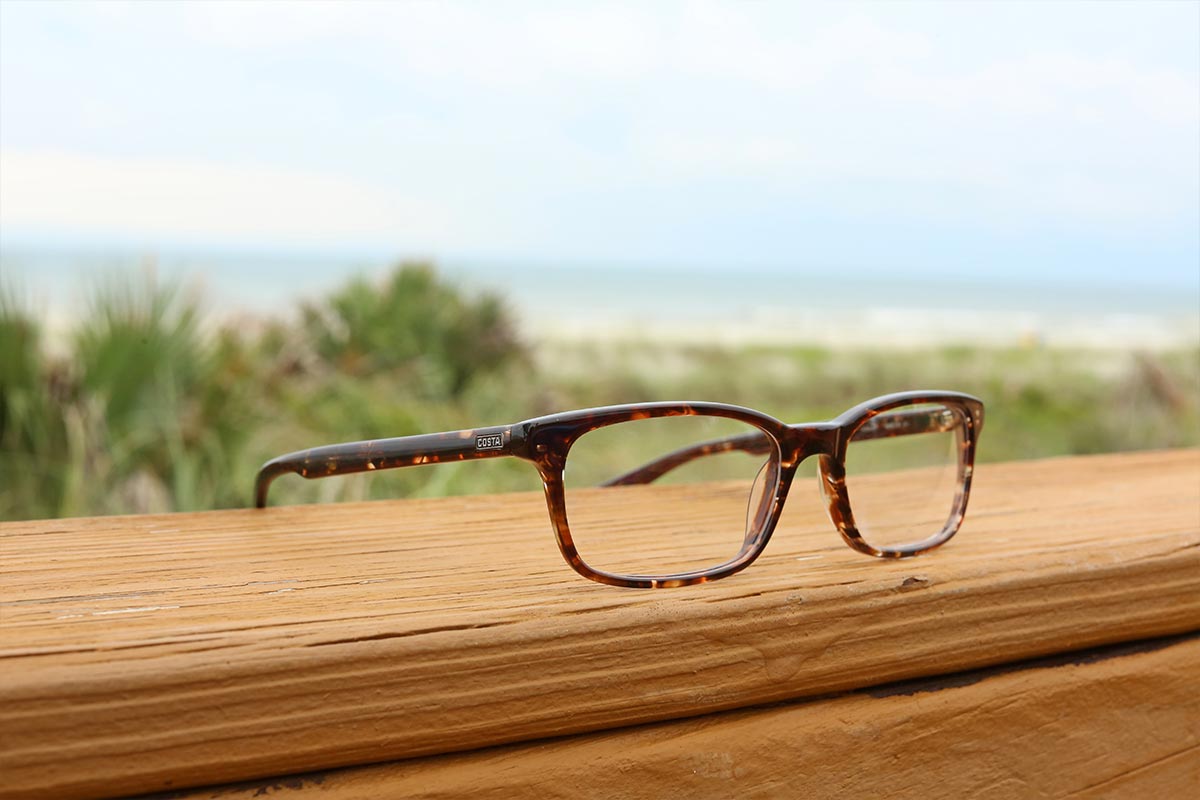 Costa optical frames photographed beside the beach