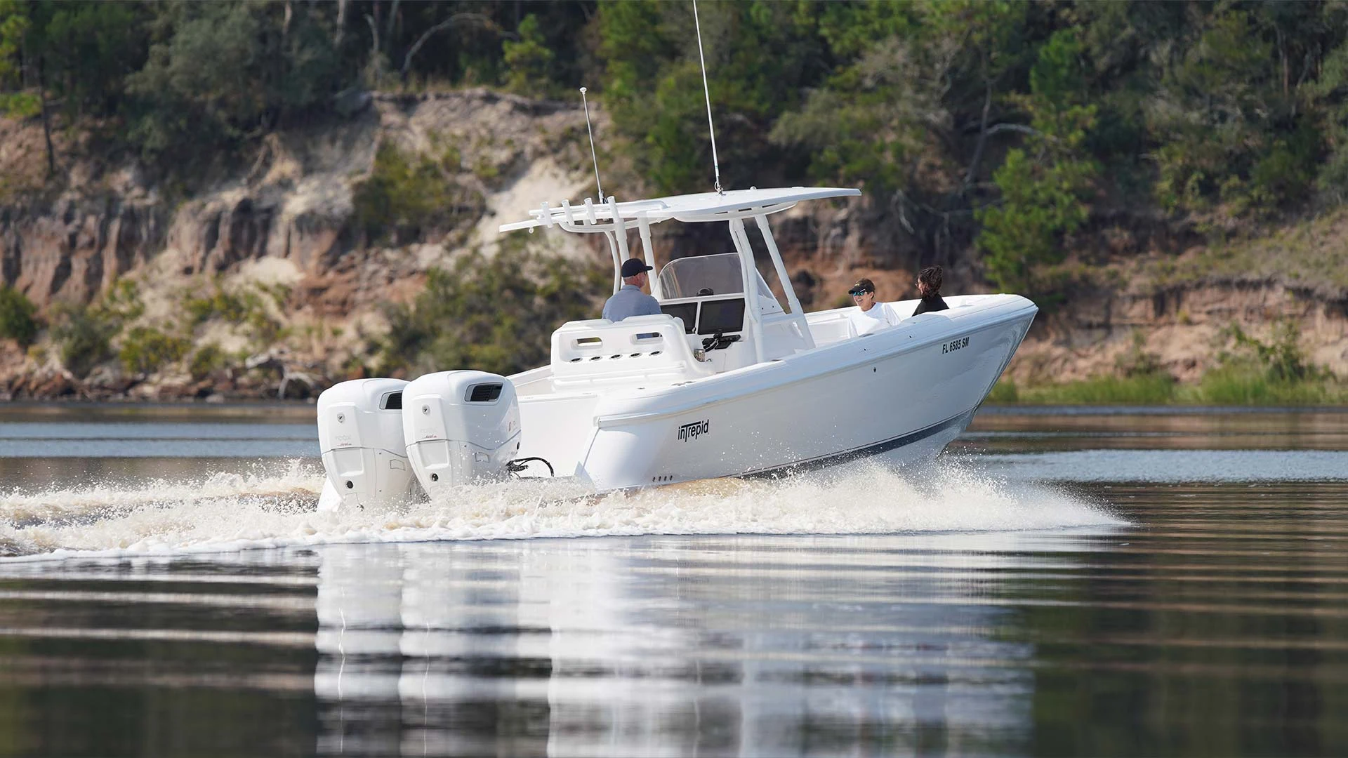 A Cox-powered center-console boat reflected in still water