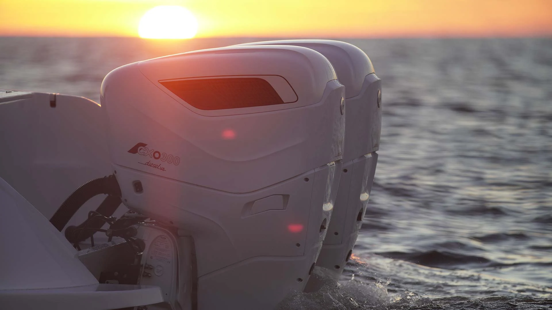 Cox outboards silhouetted against the sun at the waterline