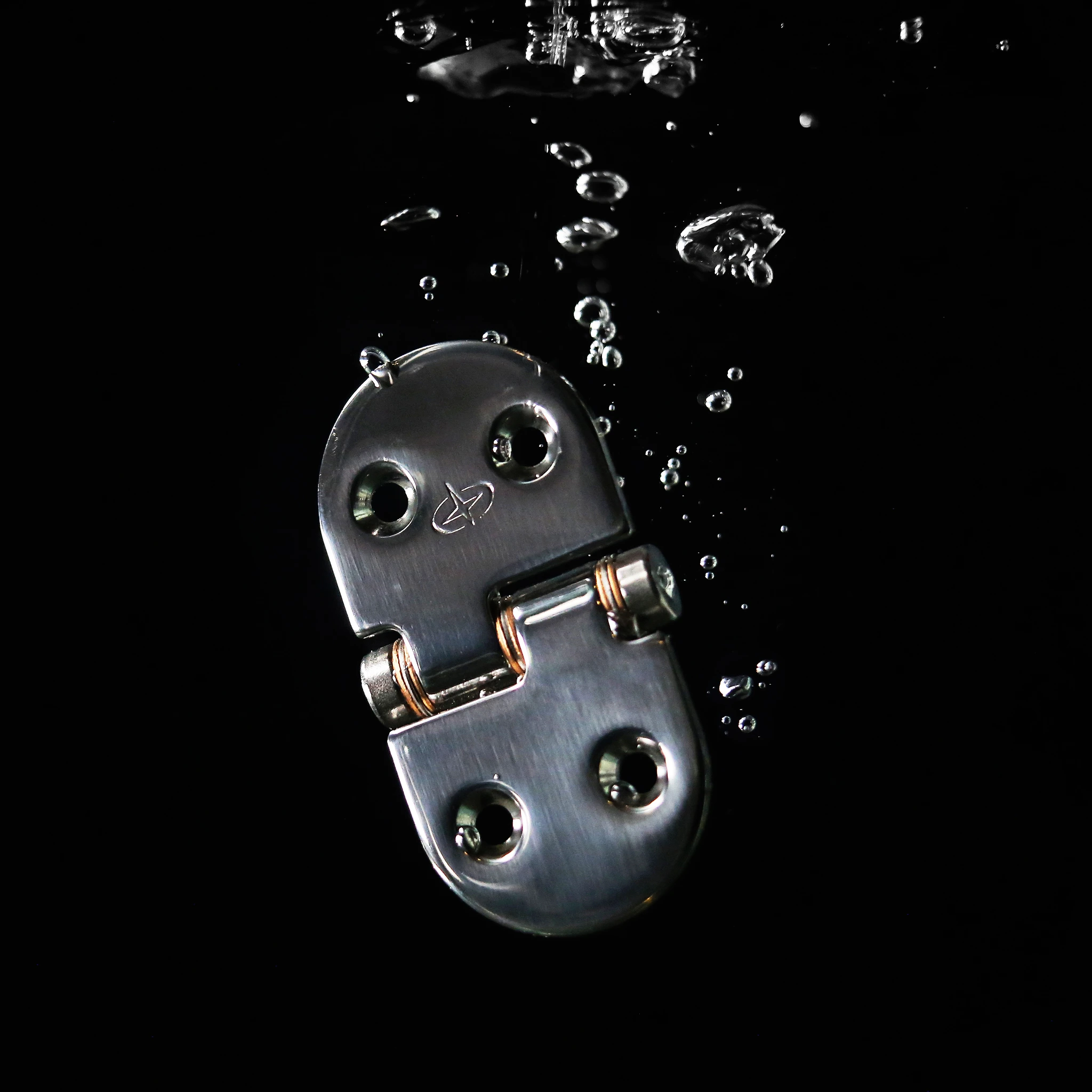 Gemlux friction hinge surrounded by bubbles against black