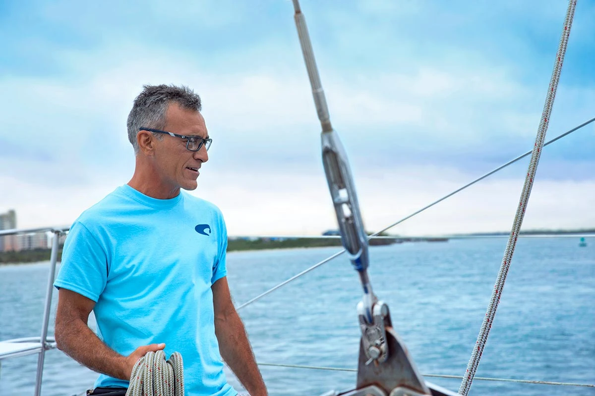 A man in Costa optical glasses on a sailboat, from Launch Pad’s Costa shoot
